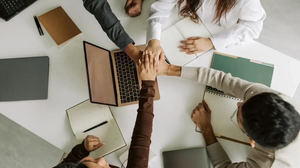 Coworkers celebrating workplace teamwork